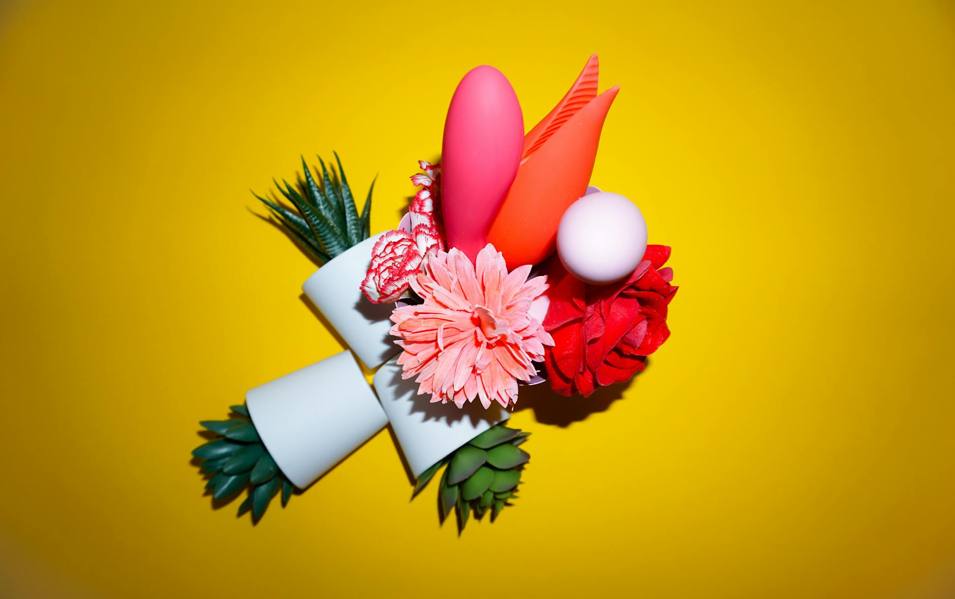 A young couple standing together indoors, holding a blue vibrator, symbolizing modern intimacy.
