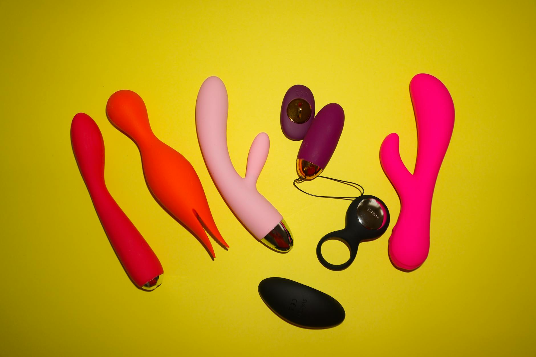 Woman holding blue silicone vibrator demonstrating modern clitoral pleasure