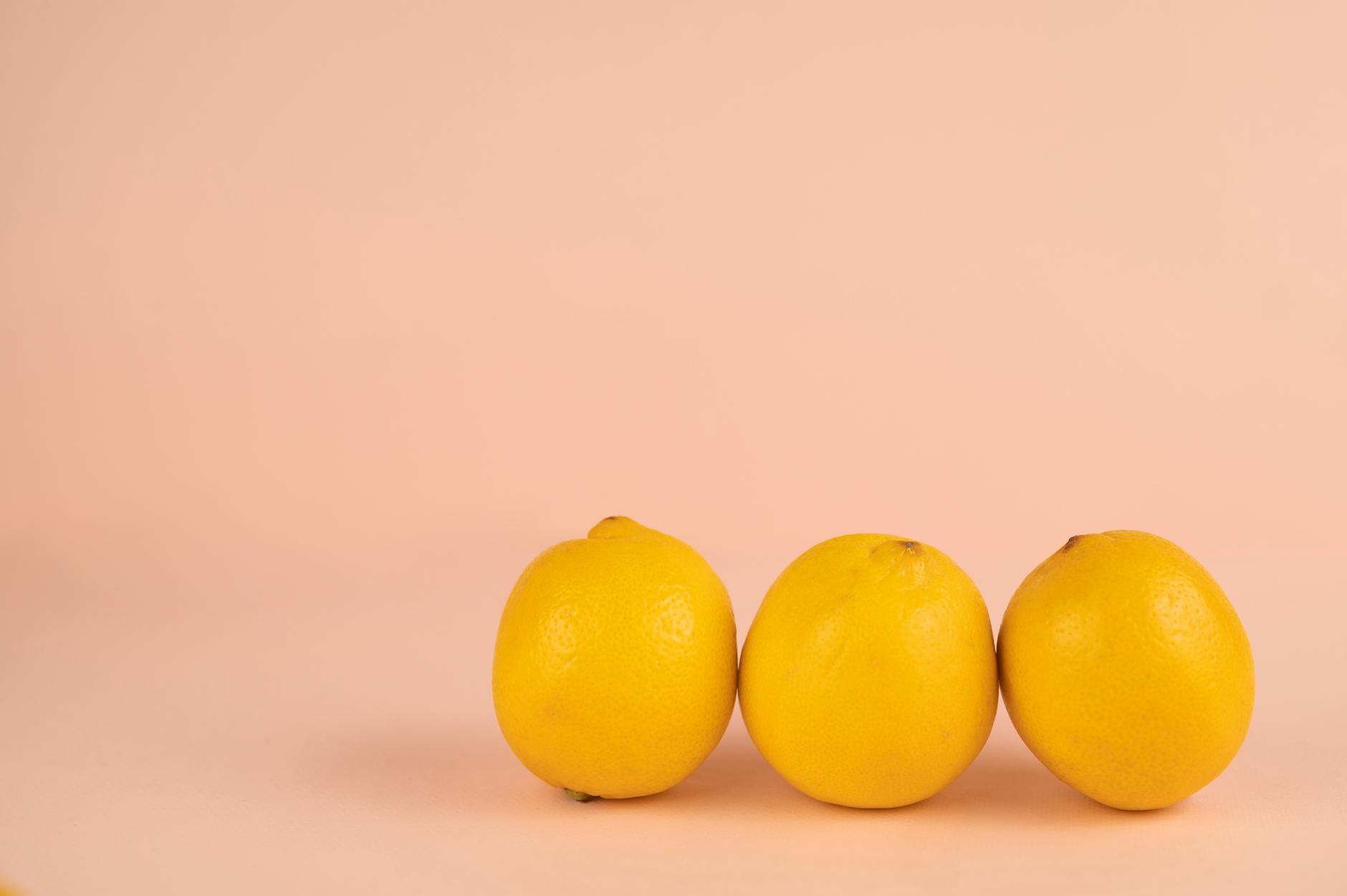 Bright ripe lemons on a soft pastel background, representing curiosity and exploration without pressure